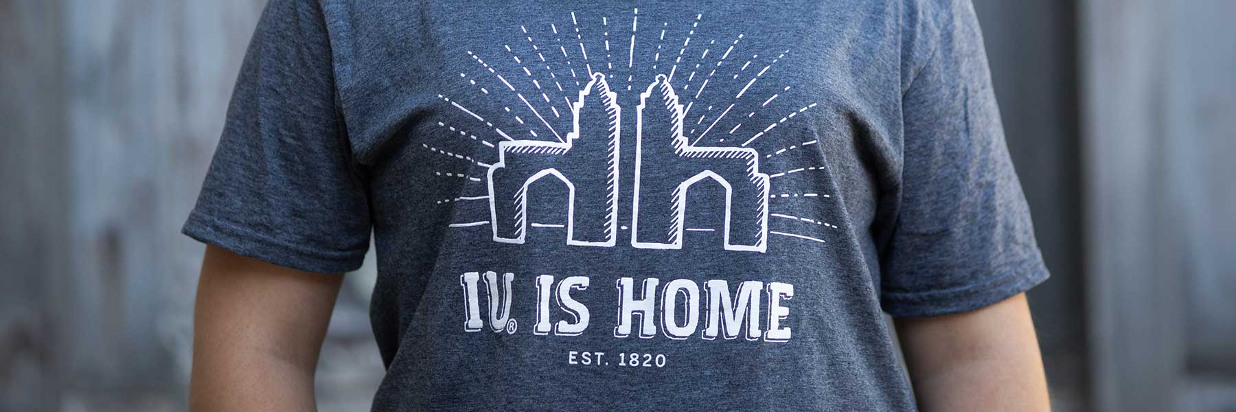 A close up on someone wearing a shirt that reads IU is home