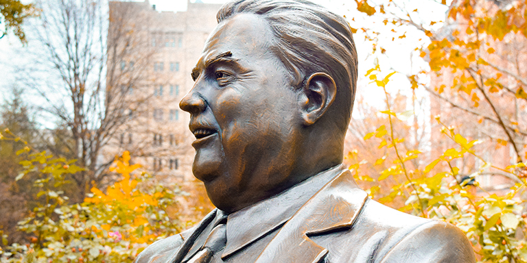 A closeup on the head of a Herman B. Wells statue.